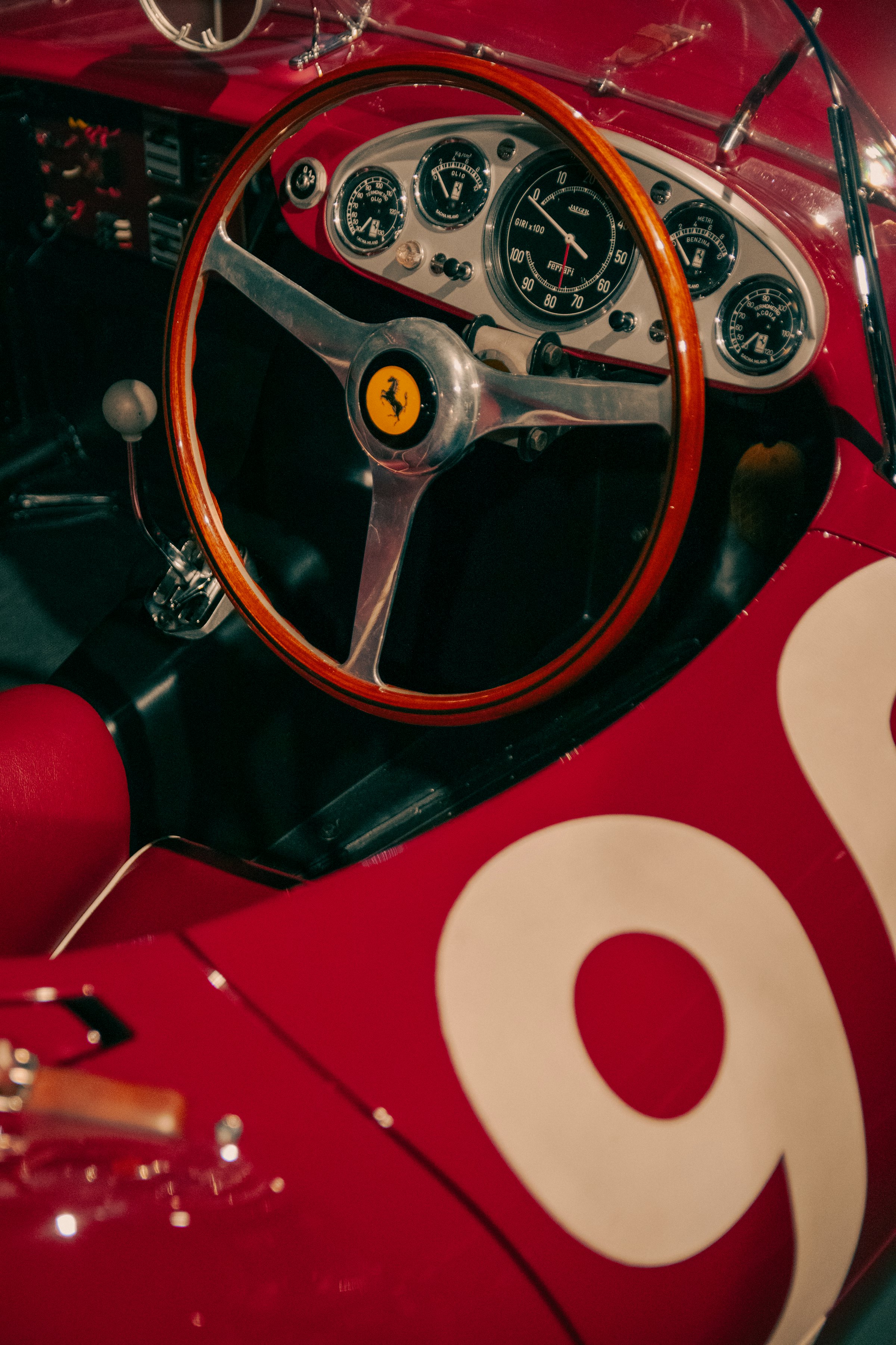 Red interior and wood steering wheel of a vintage race car
